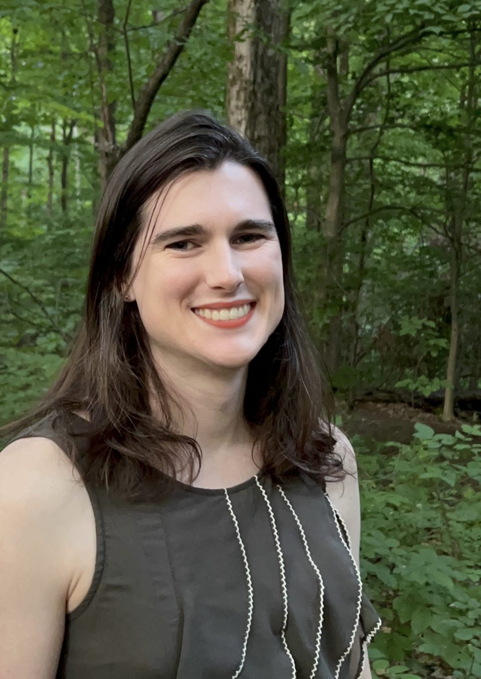 Rafaelle Lancelotta smiling outdoors among green trees